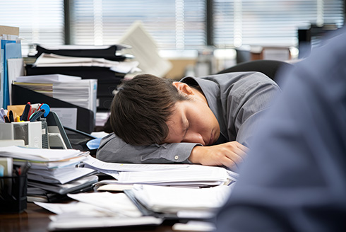 man asleep at his desk
