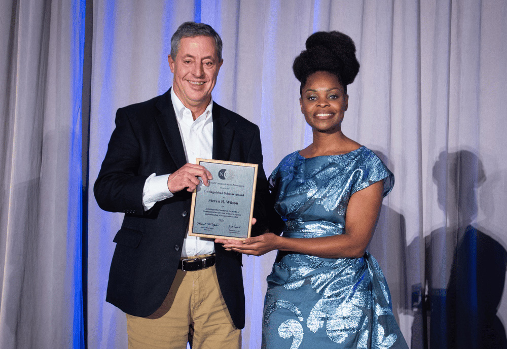 Steven Wilson (left) was formally recognized at an awards ceremony at the National Communication Association (NCA) annual meeting in New Orleans this past November (2024). Wilson is pictured with Dr. Marnel Niles Goins, NCA President and Dean of the School of Communication at American University. The Distinguished Scholar Award is the highest award given by NCA. Wilson delivered a short talk about his career at the meeting and thanked those who have mentored and supported him over the years. “I look forward to continuing to pass that on to the graduate students I work with now,” he said. (Photo courtesy of Dr. Kai Kuang)