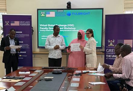 Dr. McLauchlan presenting a certificate to a participant in her Faculty Development Workshop on Virtual Global Exchange (Photo courtesy of Judithanne Scourfield McLauchlan)