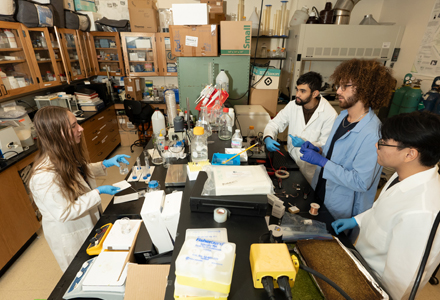 Taylor Carroll (left) with her team collaborating on their proposal for their experiment, “A Nano Encapsulated Cathode Applied to Semi-Fuel Cells.” (Photo by Corey Lepak)