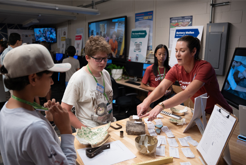 Harrison (right) working with students on displaying reconstructed finds from their archaeological excavation for the Gallery Show at the end of the week. Photo credit: Corey Lepak.
