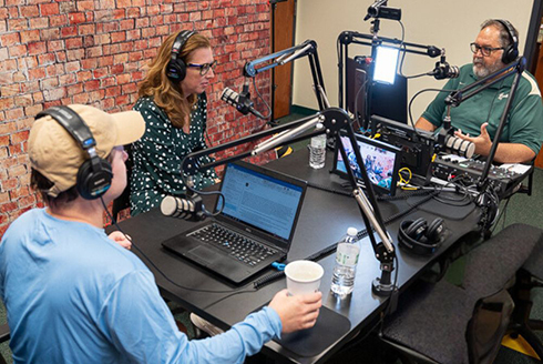 By Conduct podcasters recording in studio