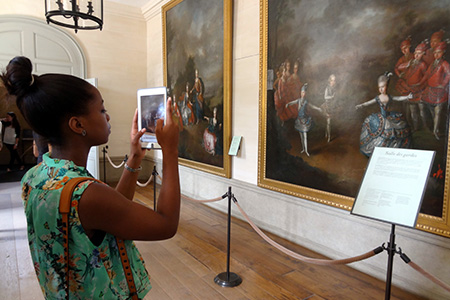 Student taking photo of artwork