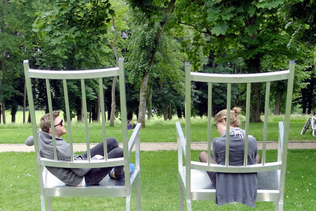 Students sitting in large rocking chairs.