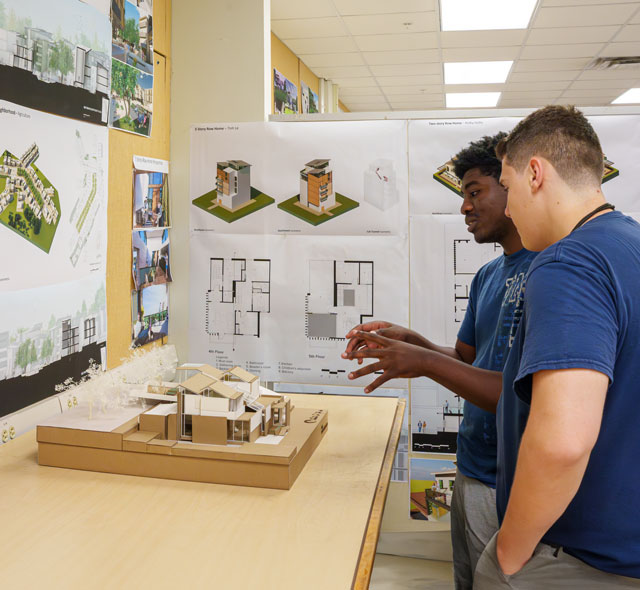 Architecture student discussing her building design before a jury in the School of Architecture and Community Design.