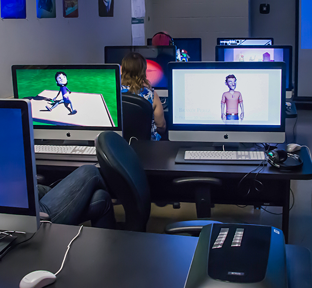 Students viewing 3D animation projects in the School of Art & Art History.