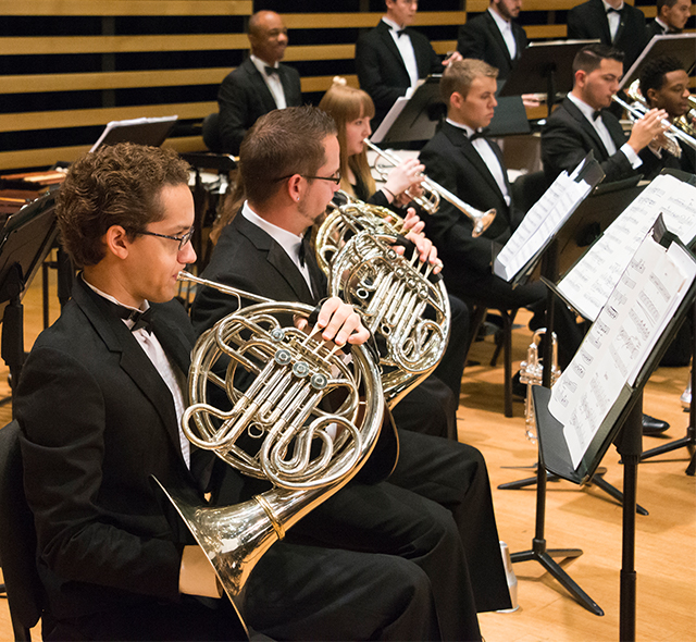 Music students performing with brass ensemble.