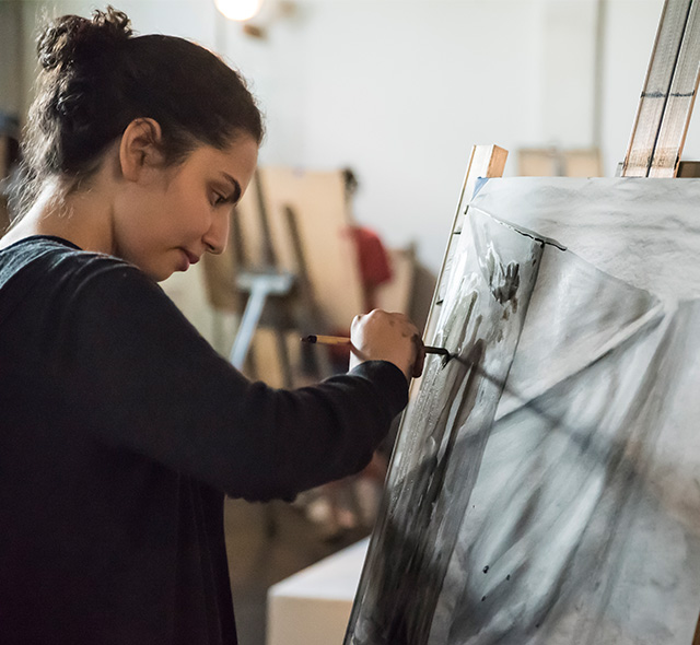 Student expressing creativity during a drawing class.