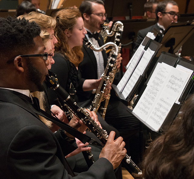 The woodwind ensemble performing on stage.