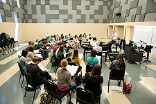Current Students - Photo of music students practicing in an ensemble rehearsal room at the USF School of Music. 