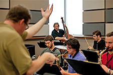 Graduate Orientation - Music students and a professor rehearsing for a concert in the USF Jazz Rehearsal Hall.