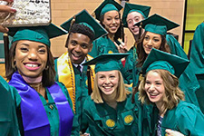 USF Graduation Application - Photo of graduating Theatre & Dance students taking a selfie while waiting for the commencement ceremony to begin