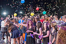 Graduation Celebration - Photo of graduating College of The Arts students celebrating on the USF Theatre 1 stage. 