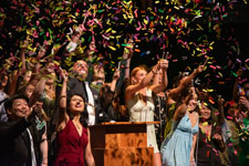 Graduation Celebration - Photo of graduating College of Design, Art & Performance students celebrating on the USF Theatre 1 stage. 