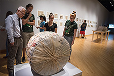 Transfer Orientation - Photo of students and a professor analysing a sculpture in the USF Contemporary Art Museum.