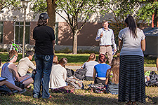 Undergraduate Orientation - Photo of students attending a lecture outdoors on the USF School of Music lawn.