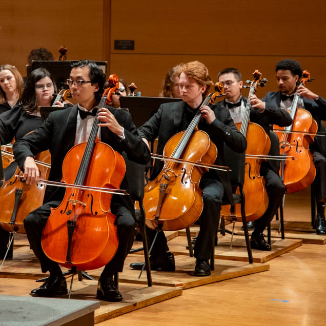 Cello players performing in orchestra