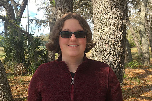 portrait of Hannah Hitchen outside with trees in background