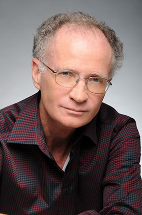portrait of Robert McCormick in front of a grey photo studio background
