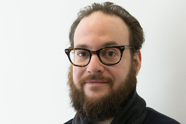 Portrait of Jason Lazarus in front of a white background.