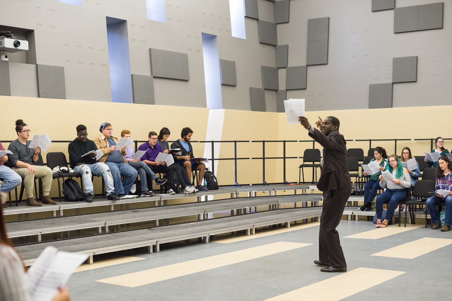 Sylvester Otieno Ogama guides USF choir students in song.