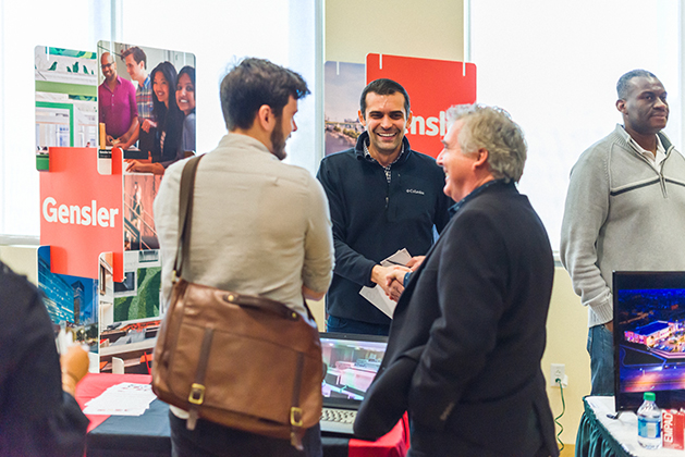 Gensler architect Higor Arruda speaks with a USF student and USF School of Architecture and Community Design Director Robert MacLeod