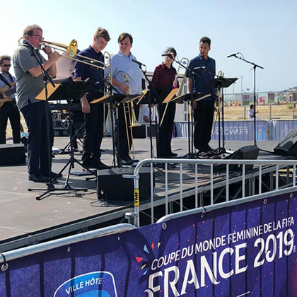 USF Jazztet and Trombone band perform on stage outside the England vs. Norway game