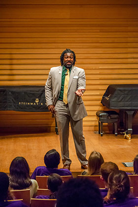 Dakeyan Graham stands on stage in front of students