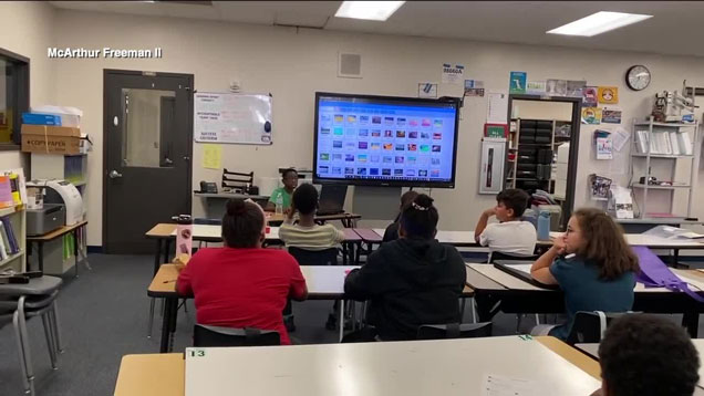 Students watch as Nathaniel McArthur gives a workshop.