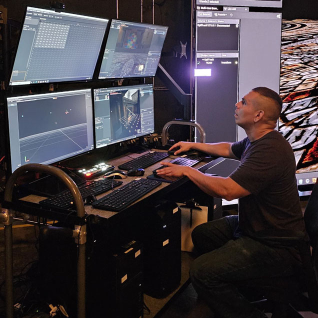Leon Peter Cruz working on a multi-screen computer.