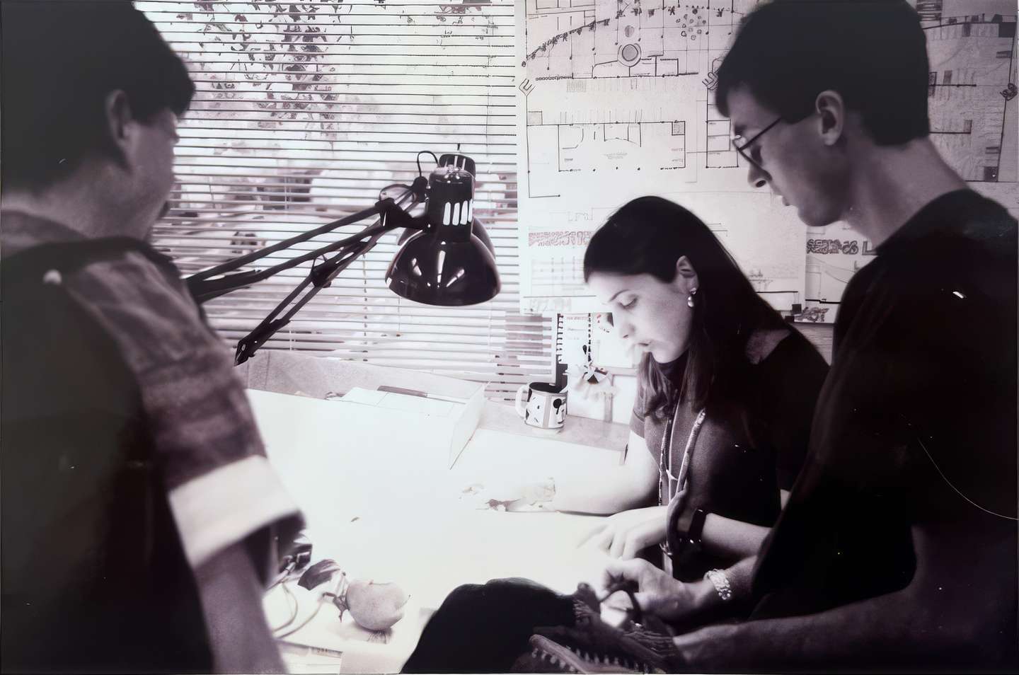 Maria working over a desk in the studio.