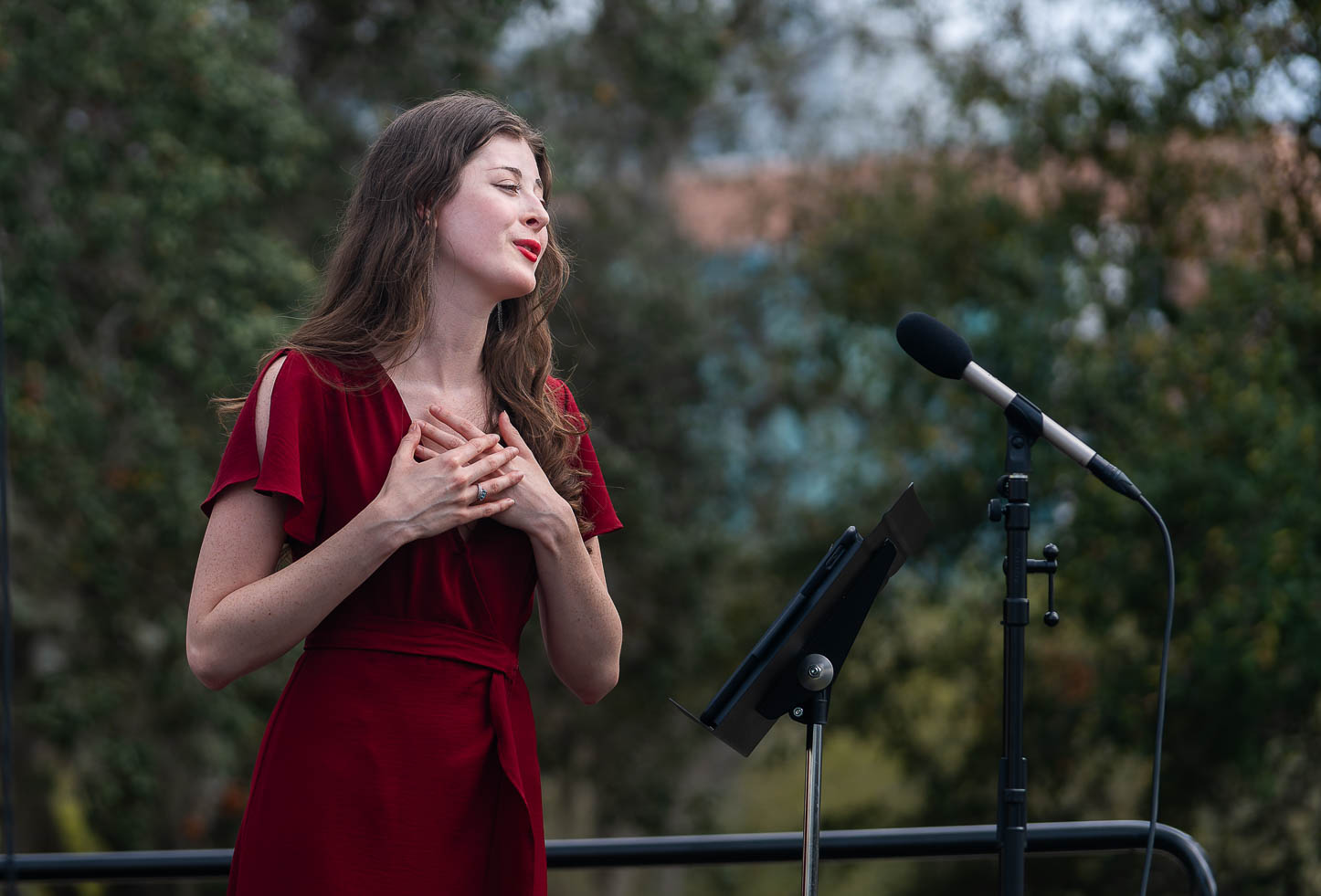 Opera singer performs outside.