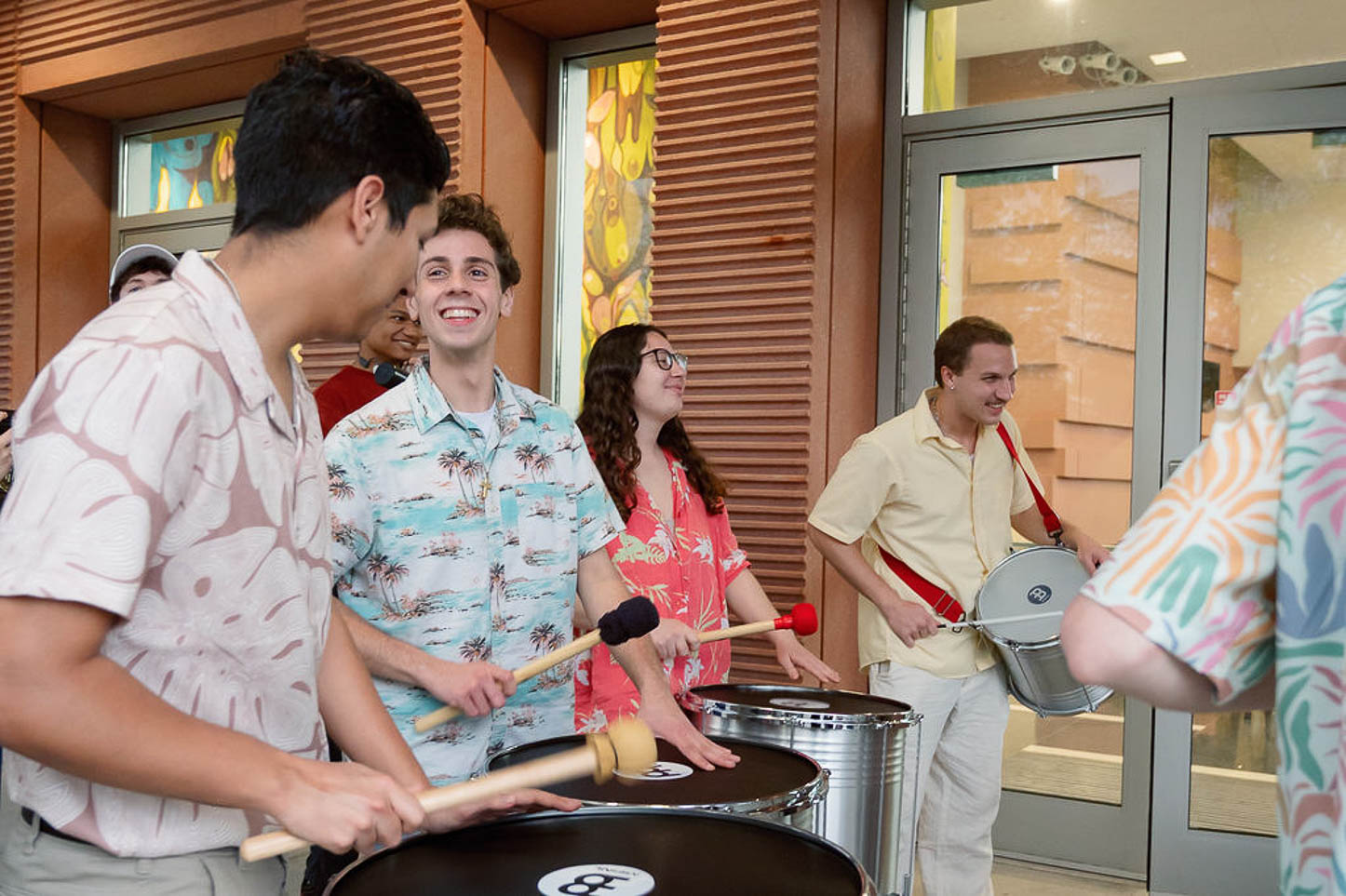 Percussionists perform outside the atrium near the Peter & Cynthia Concert Hall.