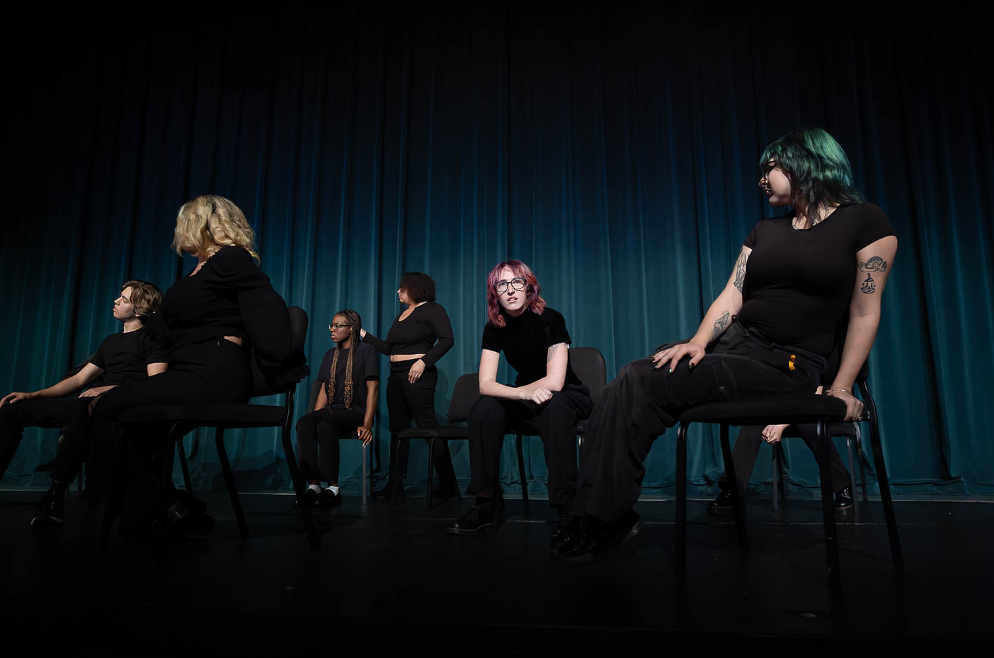 Students performing on stage in the theatre.