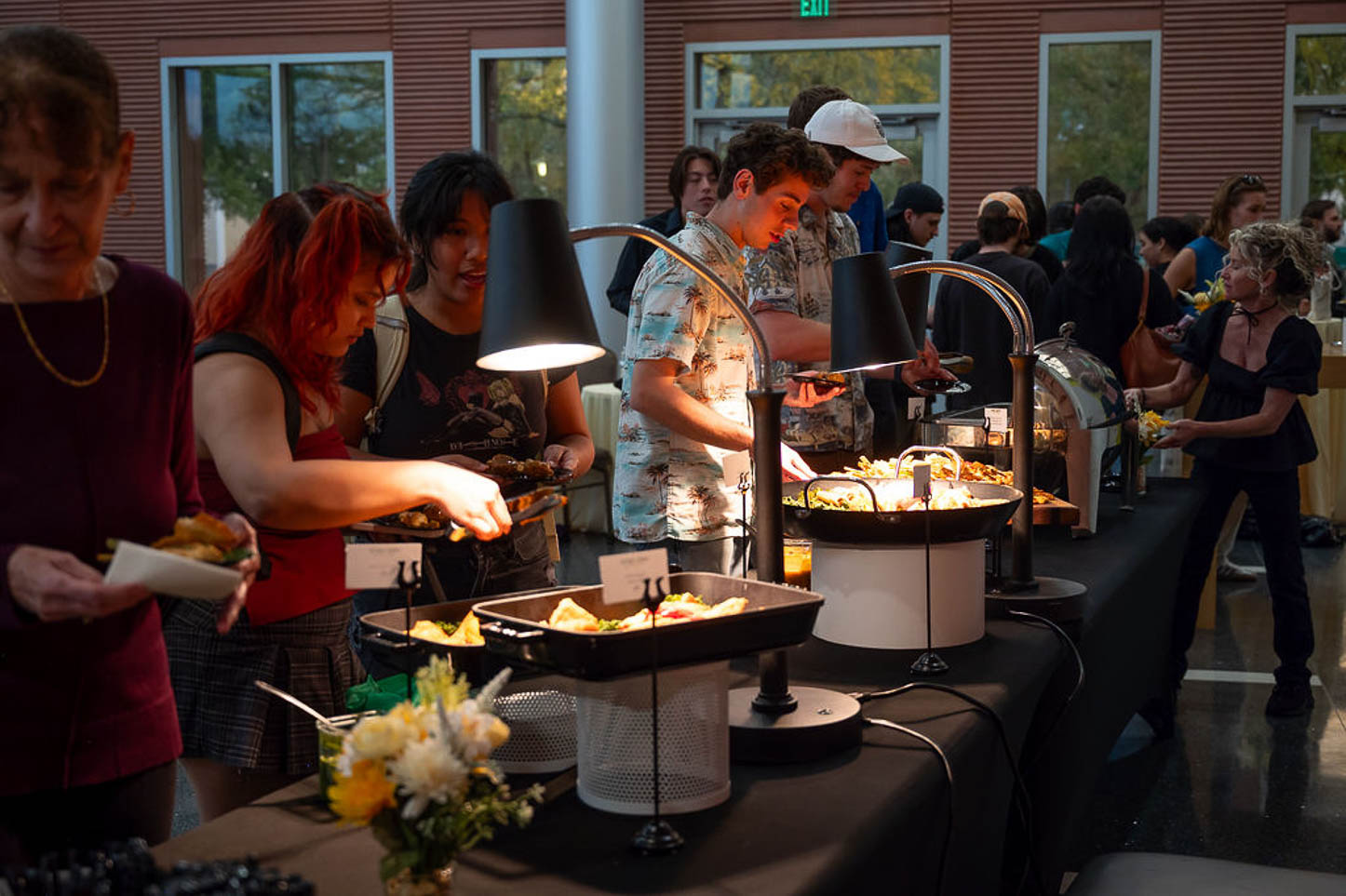 People grab food from the buffet.