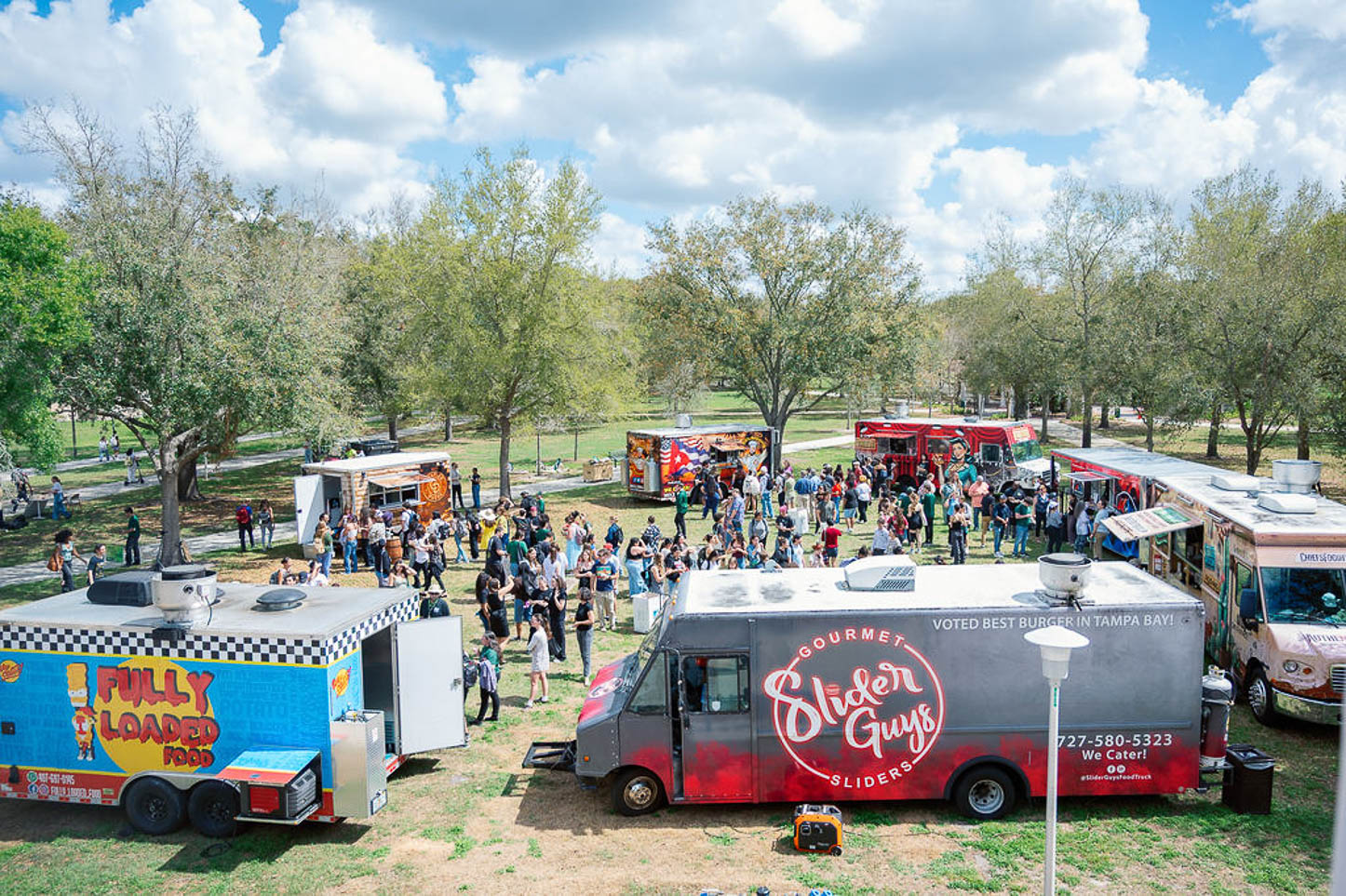 Food trucks parked on the lawn.