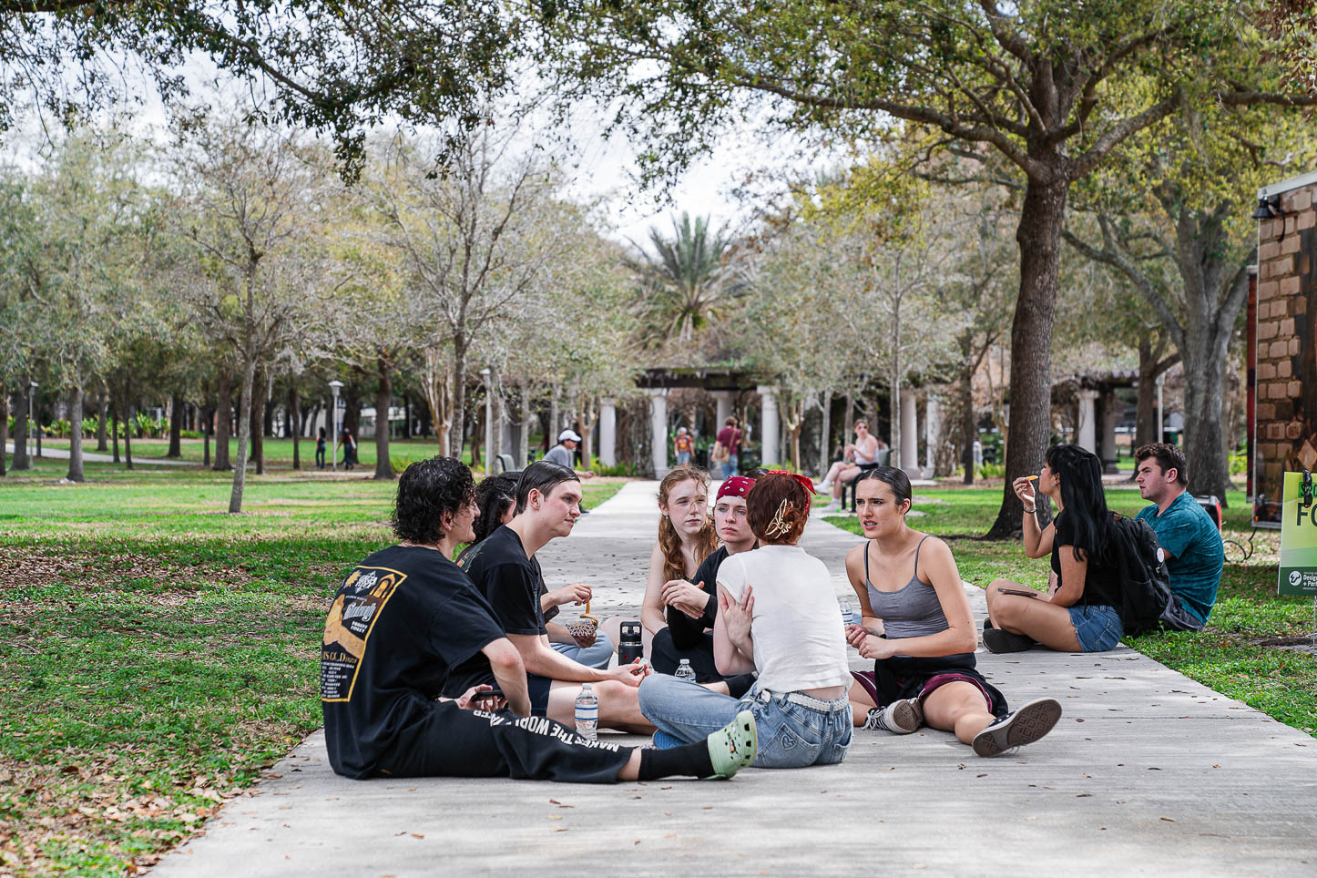 Students hanging out on the sidewalk.