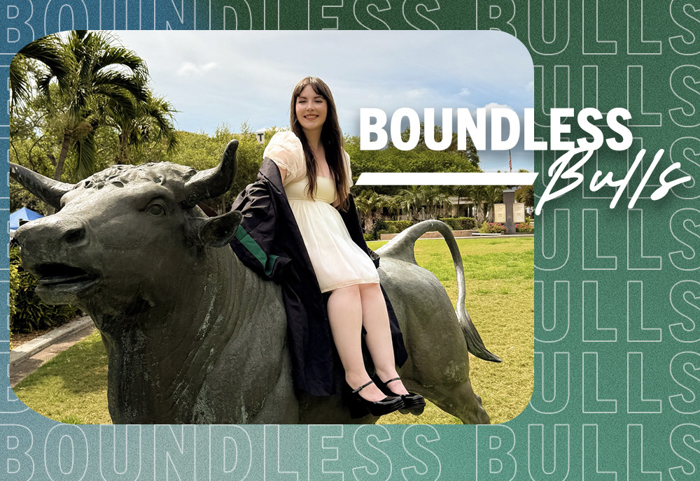 Student Alyssa Duurloo sitting atop USF bull sculpture