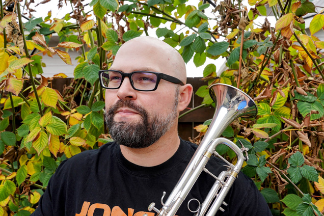 Dr. Derek Ganong holding a trumpet