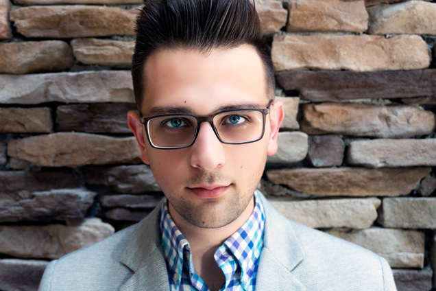 closeup of Justin Giarrusso wearing a greay jacket and blue checked shirt
