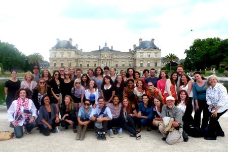 A large group photo in front of an old French manor.