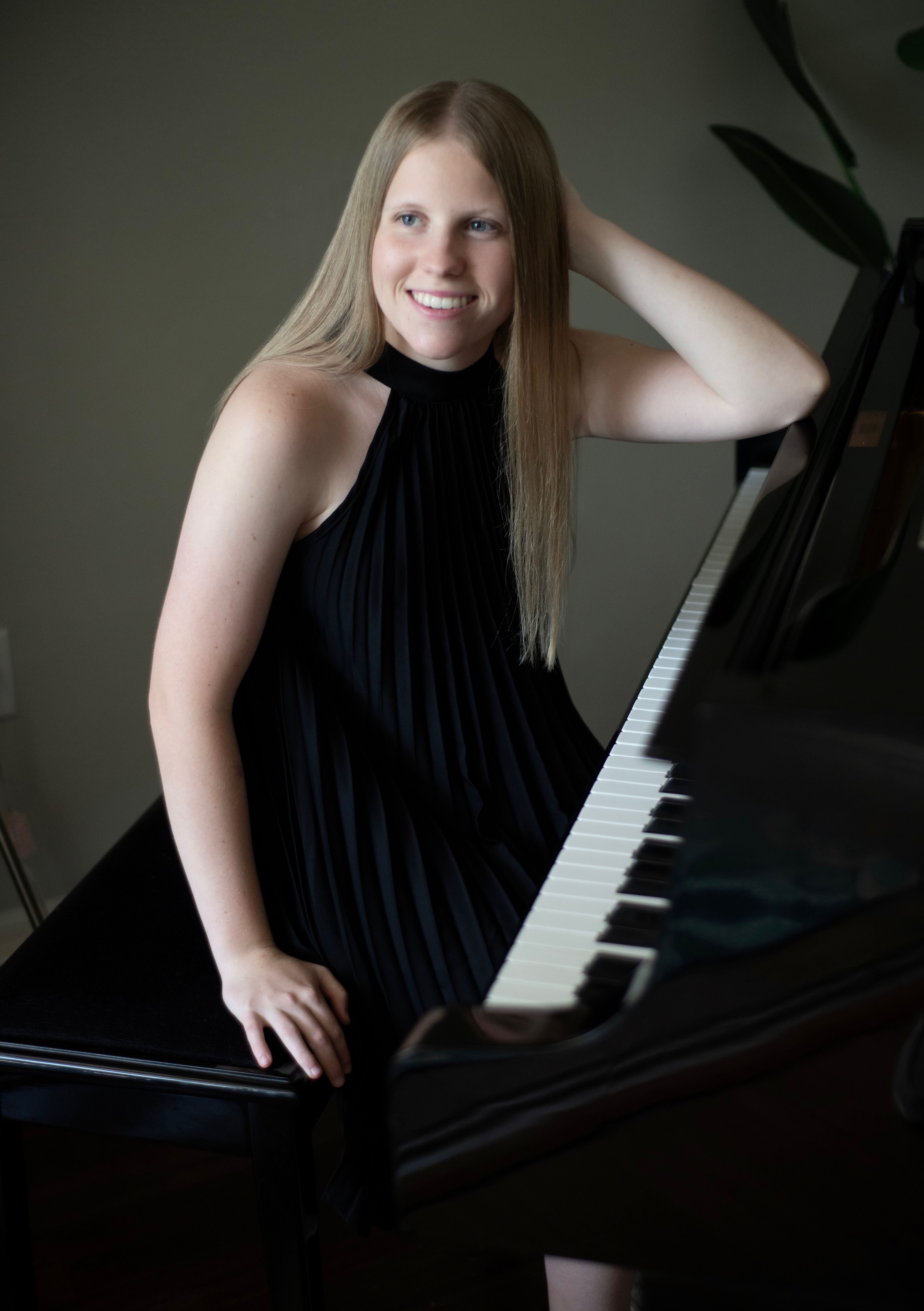Anna Snecinski sitting at a piano.