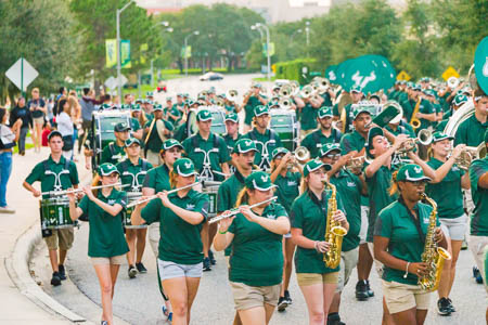 Students march on campus in the Homecoming parade.