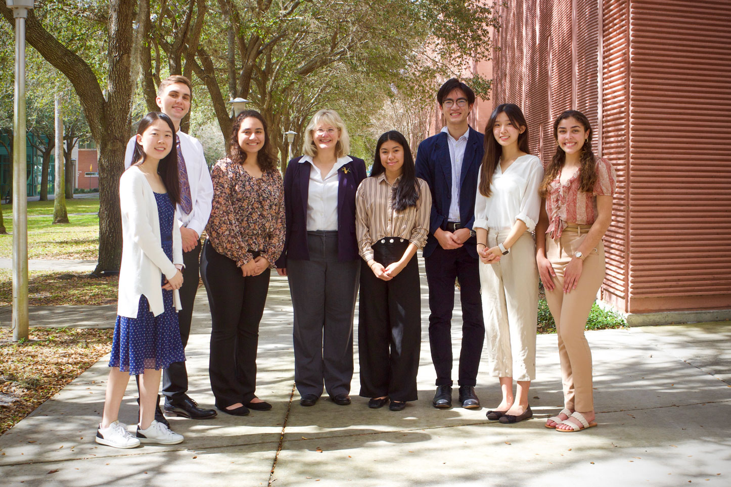 Lab personnel pictured with Dr. Bugos outside the Music building