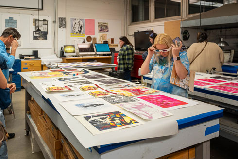 ArtHouse attendees view prints through 3D glasses.