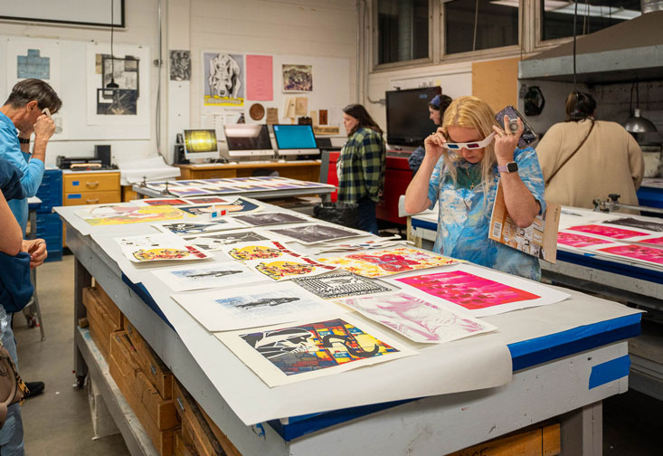 ArtHouse attendees view prints through 3D glasses.