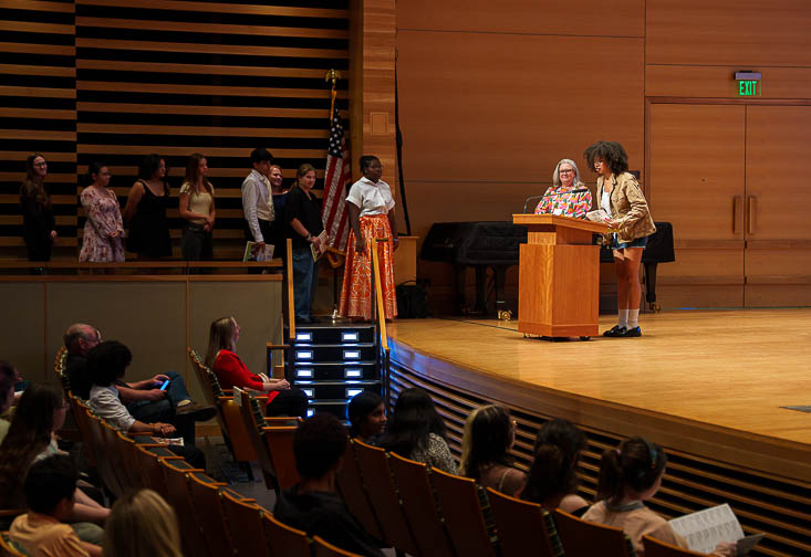 Laura Hobby, Supervisor of Visual and Theatre Arts Education for Hillsborough County Public Schools, calls students up to speak about their work.