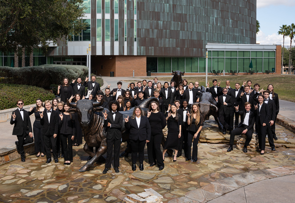 USF Wind Ensemble members in bulls fountain in front of Marshall Center.