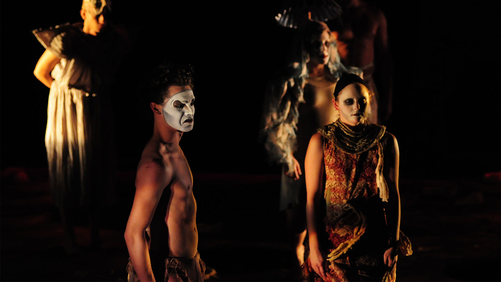 Multiple people in costume looking at a point off stage