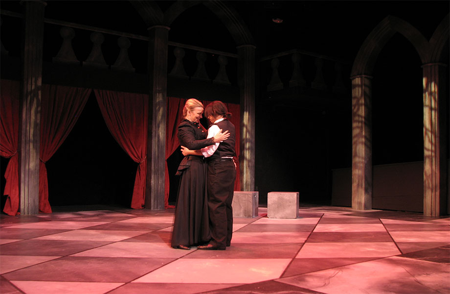 An older woman is smiling while holding a younger man in her arms, as if they were in an embrace.